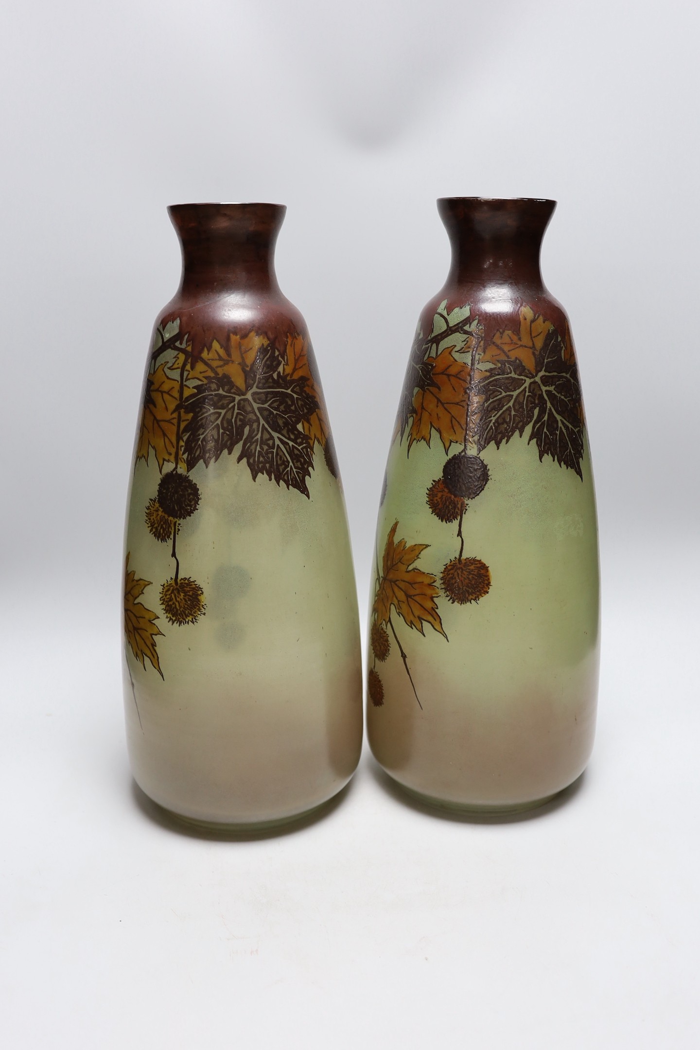A large pair of French glass enamelled vases with autumnal design. 42cm tall